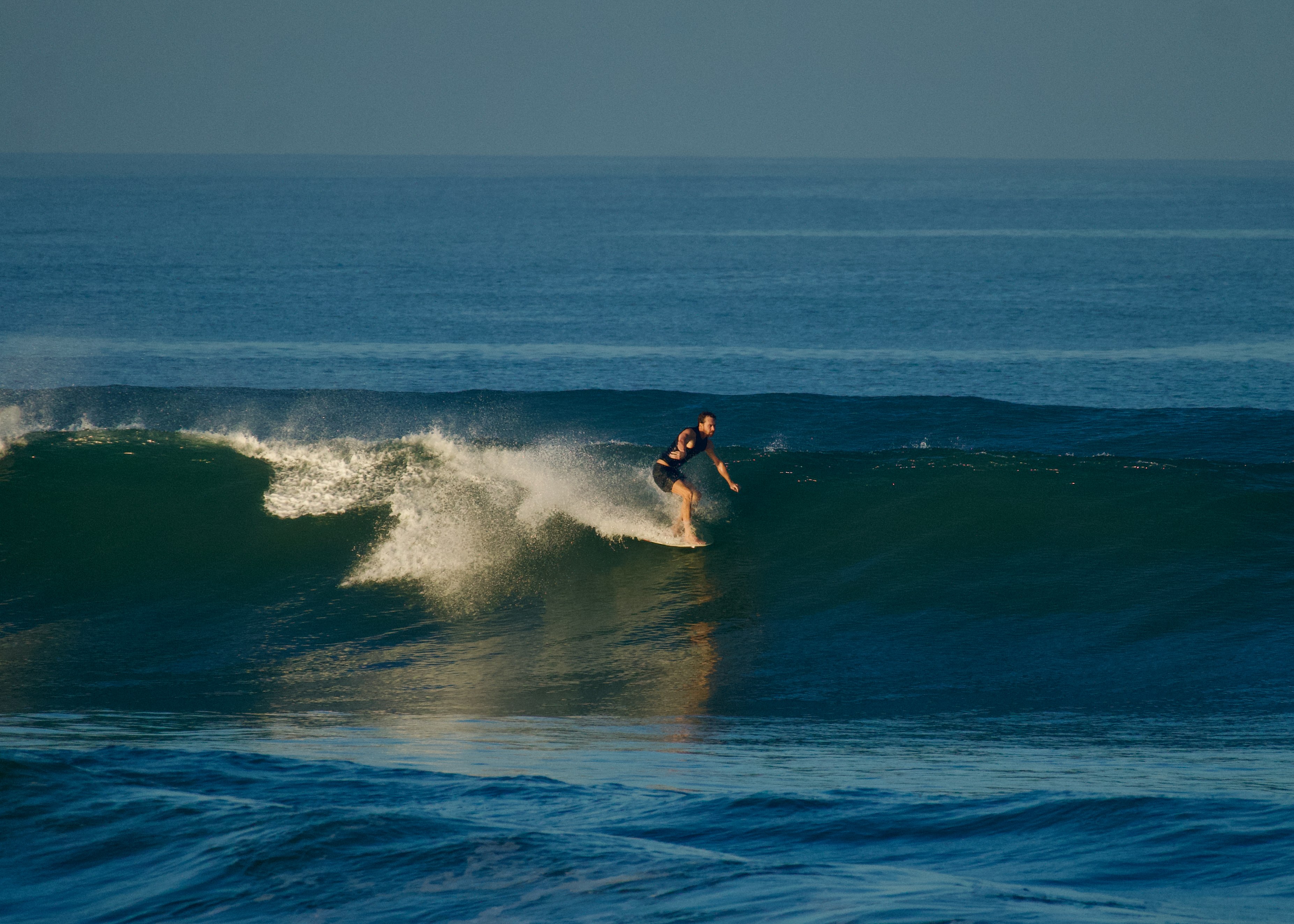 Longboarder cruising at Old Man's, Bali