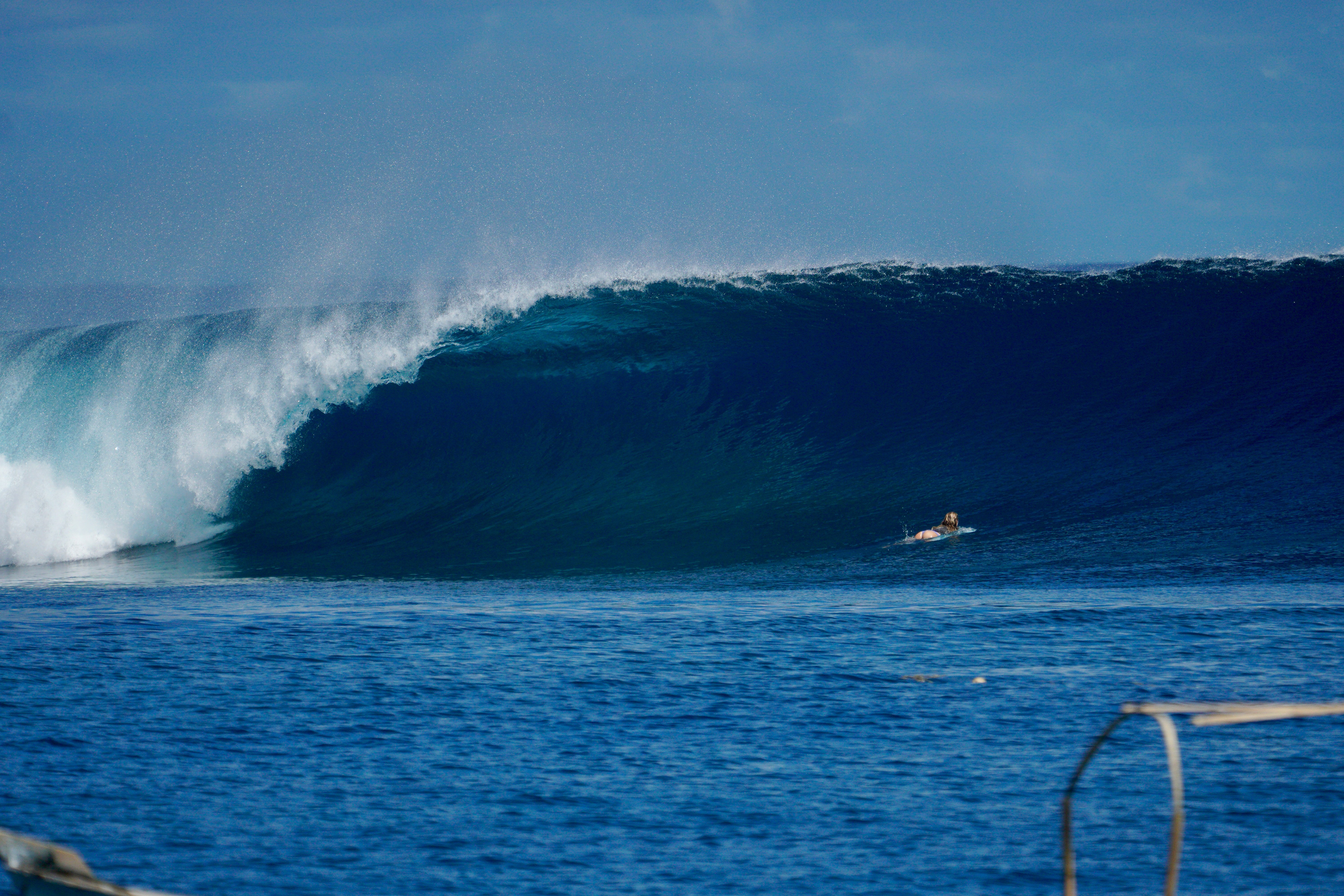 Girl duck diving a surfboard in the Mentawai islands